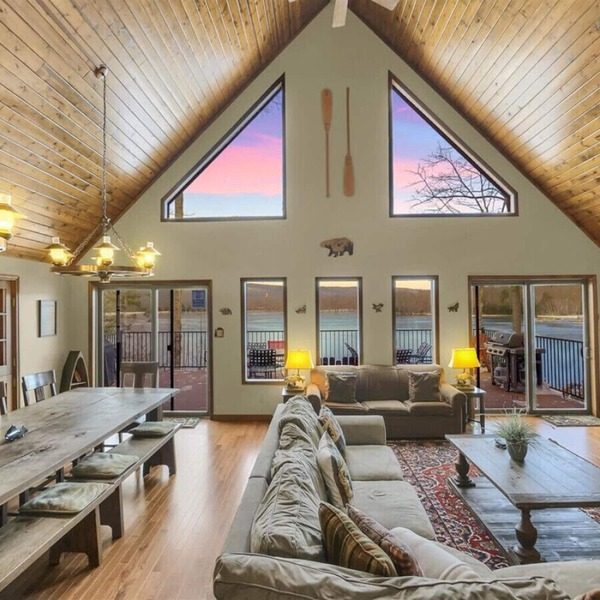 Family-friendly lakefront cabin/chalet with incredible views, private beach, lakeside firepit, boats, hot tub, multiple game rooms, and more