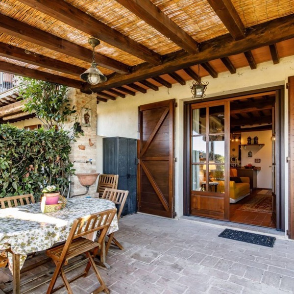 GuestHost - Nestled between the Crete Senesi and Chianti, this home offers a breathtaking view of the countryside and Siena, just a 10-minute drive away. Part of a renovated historic farmhouse, it is a well-furnished townhouse with a private garden and v