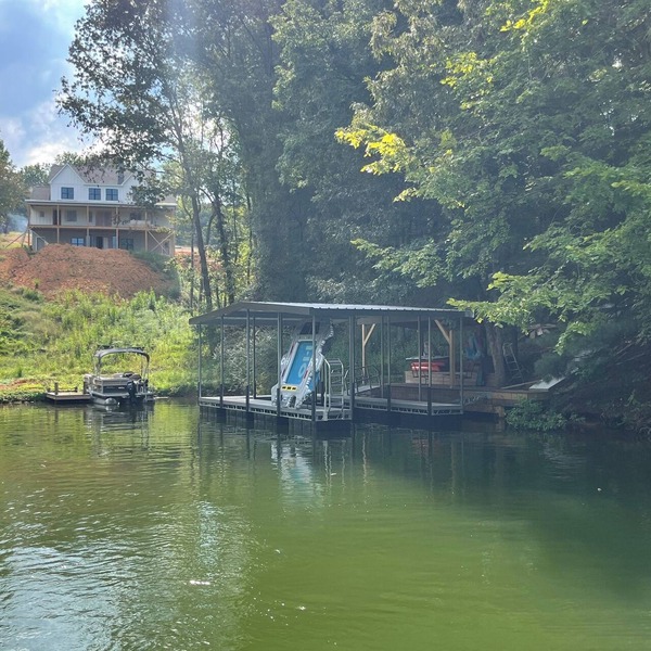 Lakefront home with dock. Cozy 2 bed 2 bath and screened in porch.