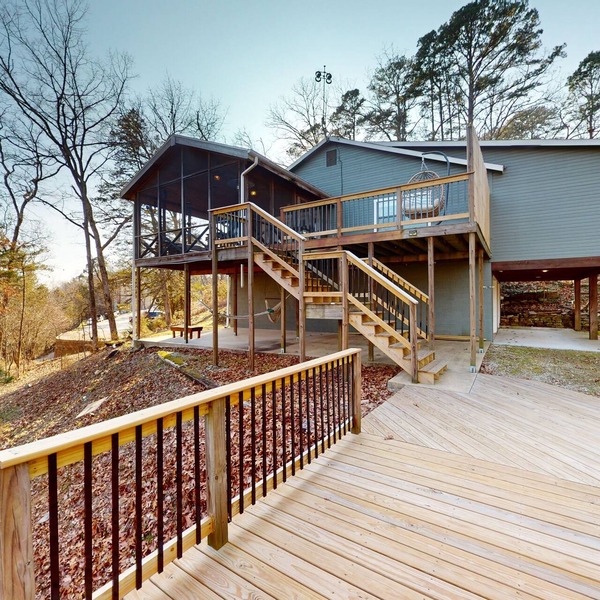 Lakefront retreat with screened sunroom, wood stove, multiple decks, & AC