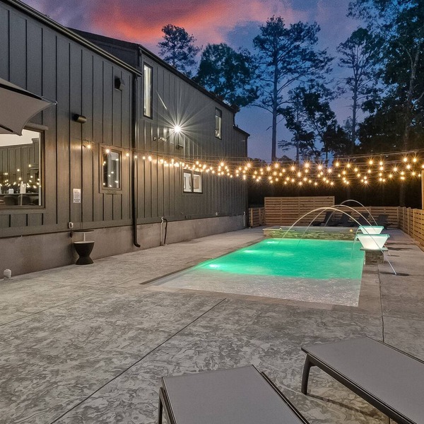 Luxury cabin lined by trees with pool, oversized sunroom, hot tub & grill