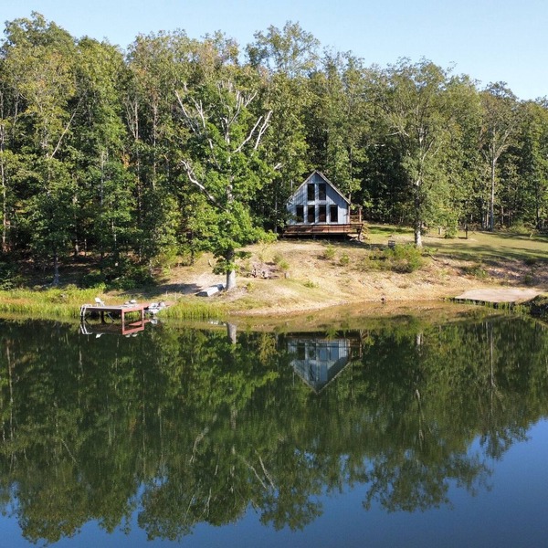 Peaceful secluded cabin nestled on 40 wooded acres overlooking 4 acre pond.