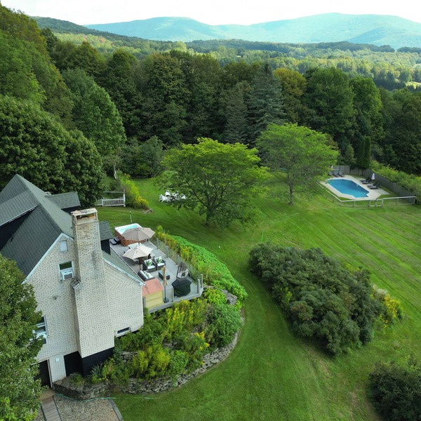 Private Contemporary Cottage with heated pool, hot tub and wide mountain views.