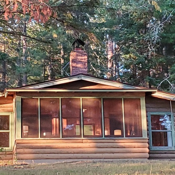Rustic cabin in remote wooded area on point overlooking lake.