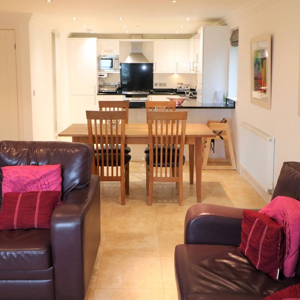 Spacious dog friendly apartment by the beach, private garden and sea views.