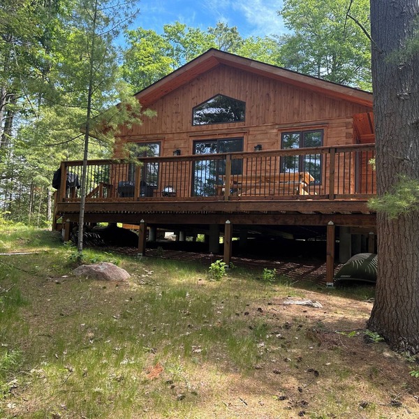 Timber cottage with large deck overlooking the water. Boat access only, no road.