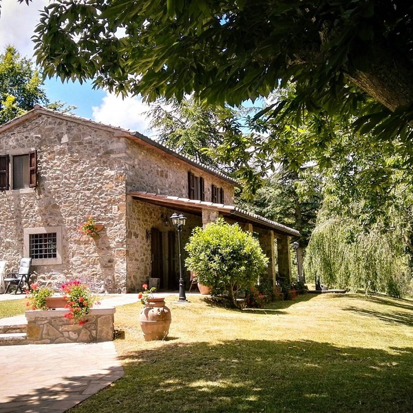 Tuscan stone villa with private pool surrounded by greenery