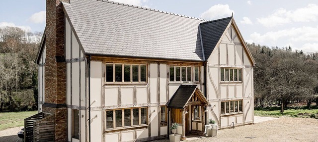A luxurious riverside cottage with stunning views, a hot tub, and fishing access.