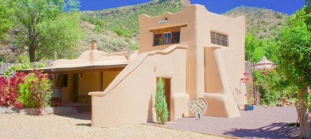 A romantic adobe, river retreat with outdoor tubs.