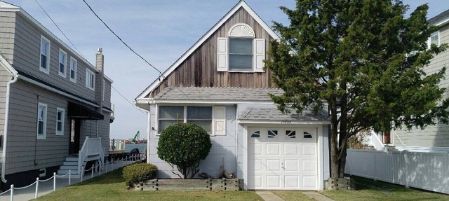 ADORABLE bay front cottage is tucked away on a quiet street with amazing SUNSET VIEWS