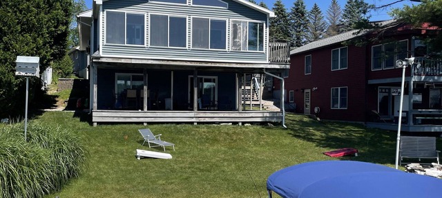 Beautiful Waterfront home with deep water dock on Onota Lake. Huge covered deck.