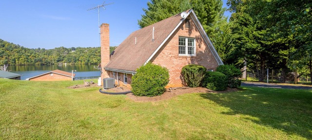 Charming lakefront retreat with cozy interiors, private dock, fire pit, and breathtaking water view