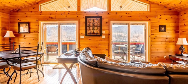 Charming riverside with stunning views, cozy interiors, full amenities, and spacious decks.