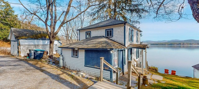 Dog-friendly cabin on the water with a sunroom, firepit, & full kitchen