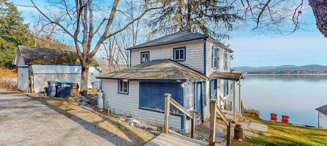 Dog-friendly cabin on the water with a sunroom, firepit, & full kitchen