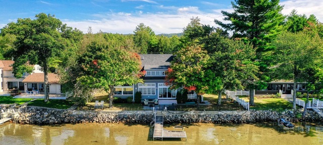 Dog-friendly lakefront home with lake views, firepit, dock, patio, & grill