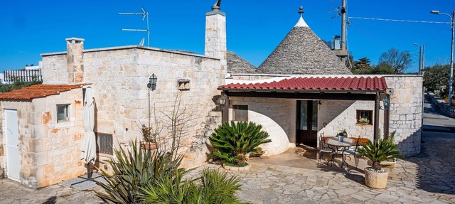 Historic trulli surrounded by ancient olive trees
