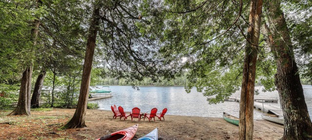 Inviting lakefront house with dock, sandy beach & screened porch