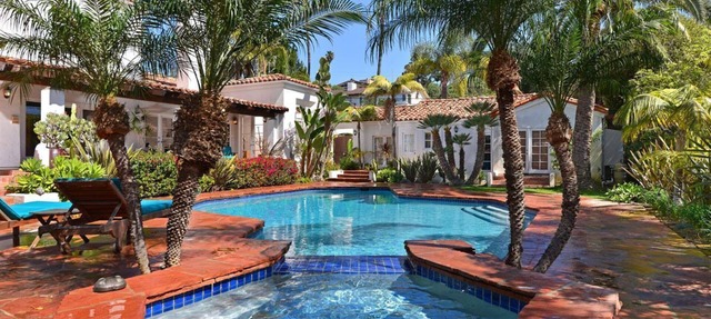 Mediterranean magic in a sun-kissed tropical oasis with pool and pizza oven.