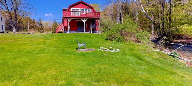Red barn retreat with river views, hot tub, deck, firepit, & large yard