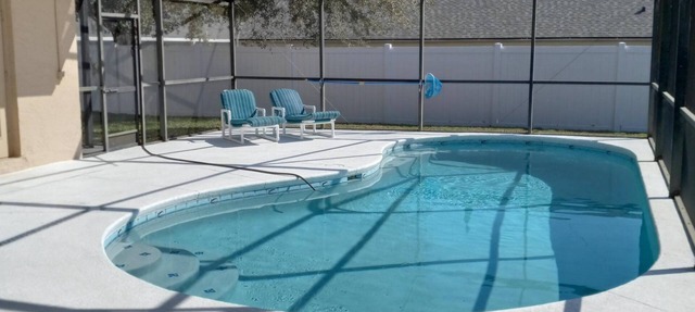 South west facing pool with privacy fence