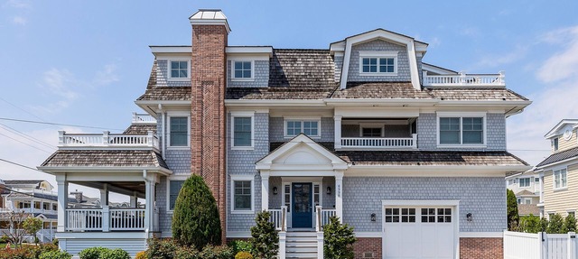 Spacious deck has ocean views as home is across the street from the beachblock.