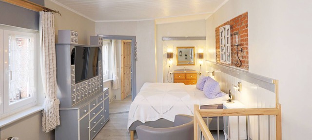 The open plan maisonette apartment extends over two floors in the back house