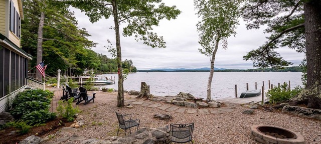 Timeless lakefront home on Lake Winnipesaukee with screened-in porch and dock