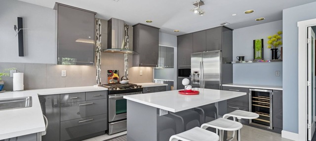 Top-level duplex featuring a sleek open concept kitchen with stainless appliances, cozy fireplace, stylish furnishings, and in-unit washer/dryer. Designed for basking in the sun under skylights in thoughtful details throughout.