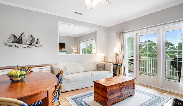 2nd-floor retreat with screened porch, shared pool, WiFi, central AC & elevator