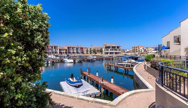 3BR townhouse in secure canal complex with double garage, walk