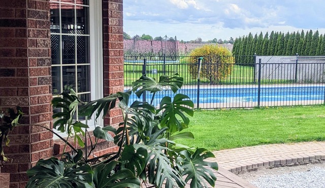 A poolside guest stay nested in a beautiful orchard along winery route