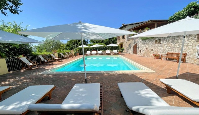 A two floor detached house with a patio/terrace & a large garden