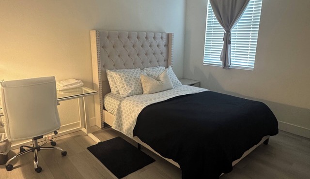 A3- Comfortable queen bedroom in Roseville with TV and desk
