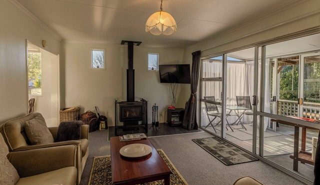 Amongst trees is this quaint cottage & within a 5-minute walk to town & beach