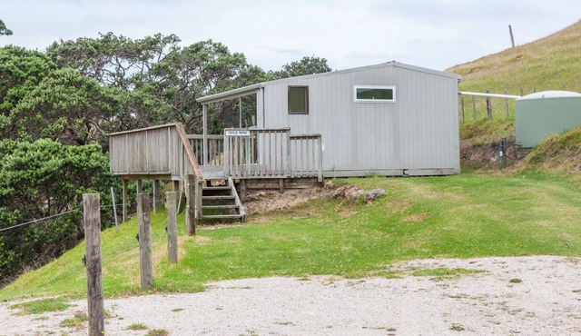 Basic holiday cabin with its own private sandy bay