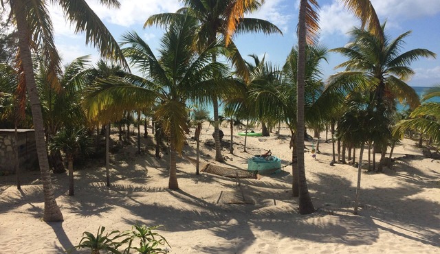 Beachfront views of pristine sandy beach, clear blue waters and surreal sunsets.