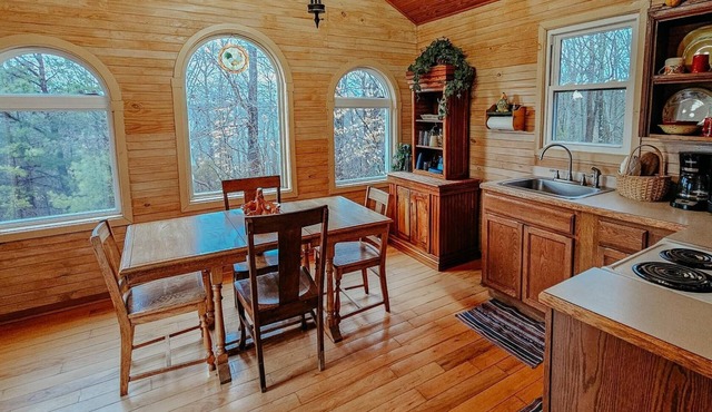 Beautiful, authentic log cabin with acres of land, fishing pond, and hot tub.
