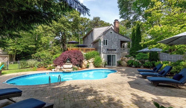 Beautiful Eastham home featuring lush gardens with heated in ground pool