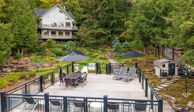 Beautifully landscaped with a sandy beach, outdoor sauna, hot-tub and ample water toys.