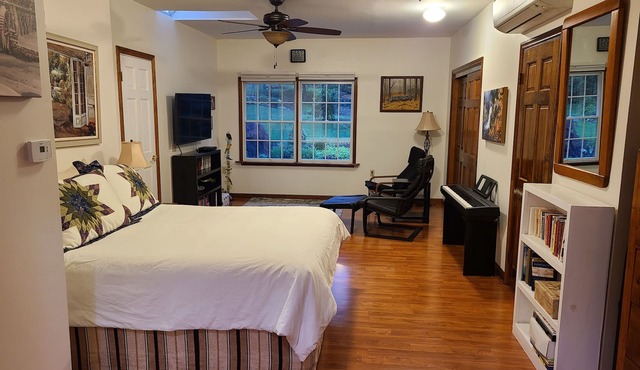 Bedroom, bathroom with beautiful shower, second room with work or eating area.