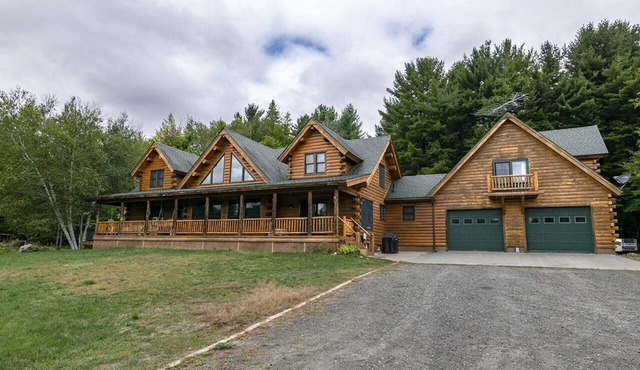 Cedar Log Home sits on 41.87 private acres with mountain and meadow views