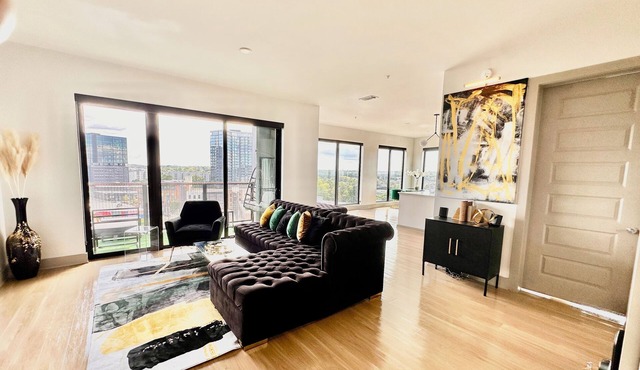 Ceiling to floor windows featuring a private balcony with stunning city views!