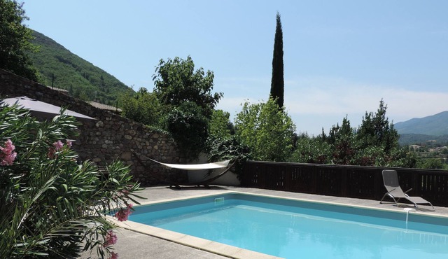 Charming holiday home with large swimming pool, nestled in a mature garden.