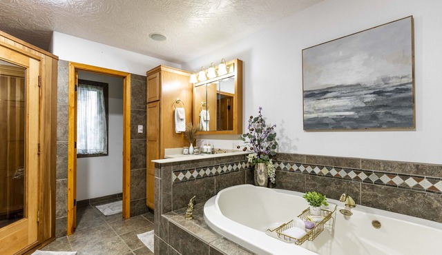 Charming house with sauna, jetted tub, and pool table. Cozy open floor plan.