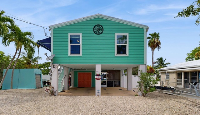 Coastal canalfront home with swim spa, dock, kayaks, e-bikes & dog friendly