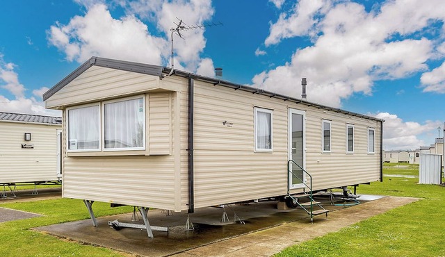 Comfortable modern 12ft-wide caravan with one double and two twin.