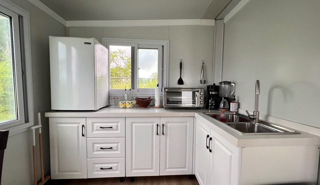Comfy and cozy mini house sitting on a beautiful 1500 meter lot. Great location!