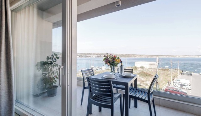 Cosy Mellieħa apartment just steps from the beach with sea views, terrace, 1 bedroom + ensuite, modern kitchen & lift access. Perfect for couples or business stays.