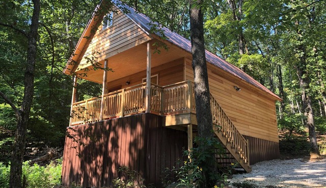 Cozy tiny cabin nestled in a little woodland village – playground, pond and more